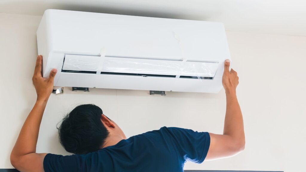 A technician holding the AC